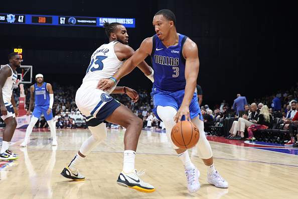 Dallas Mavericks' Grant Williams drives past a Minnesota Timberwolves defender in Abu Dhabi.